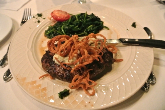 Grilled Chopped Steak - topped with gorgonzola cheese and fried onions served with sauteed spinach and roasted tomato