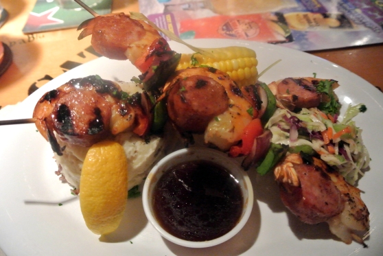 Kentucky Bourbon Skewers - Large Shrimp skewered with Red and Green  Bell Peppers, Red Onion and Andouille Sausage, then brushed with a tangy Kentucky Bourbon Sauce. Served with Mashed Potatoes  and Corn on the Cob.